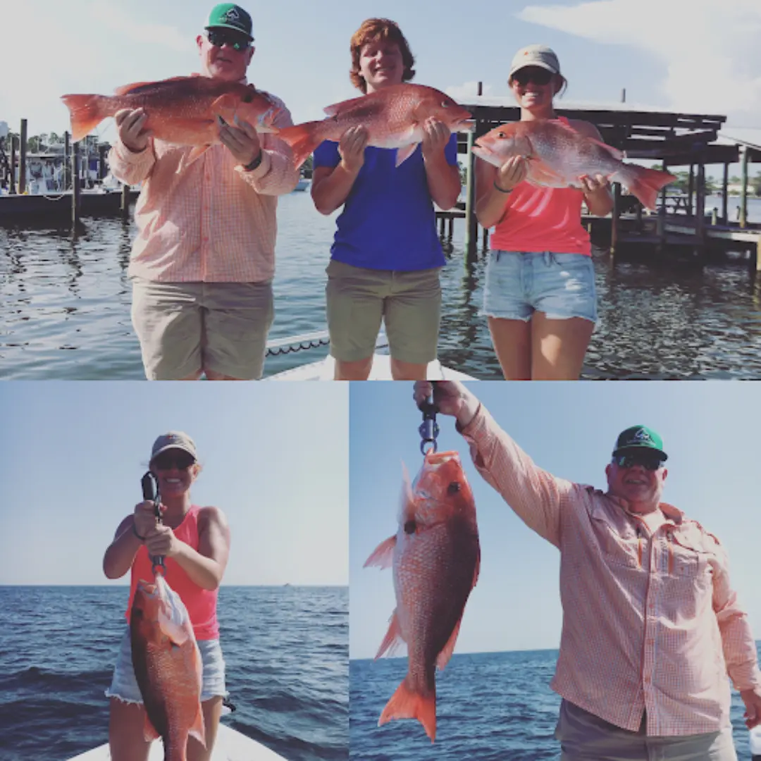 Several people who've successfully caught their red snapper in orange beach with Navigator Charters.